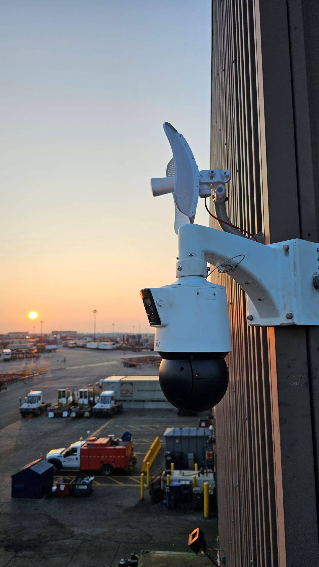 CCTV camera surveillance, on the side of a warehouse.