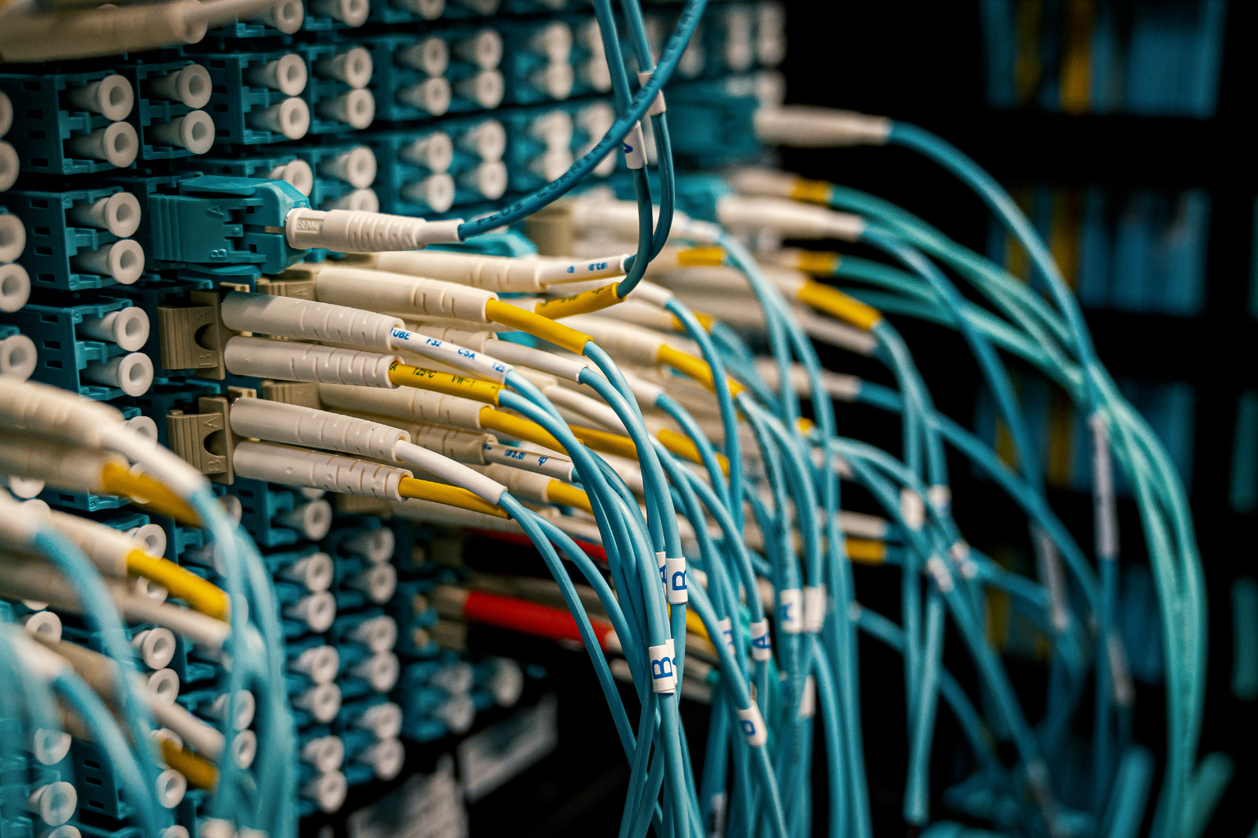 Fiber optic cables plugged into wall